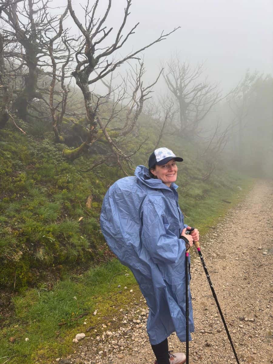 Liz in her Altus poncho in morning fog and drizzle