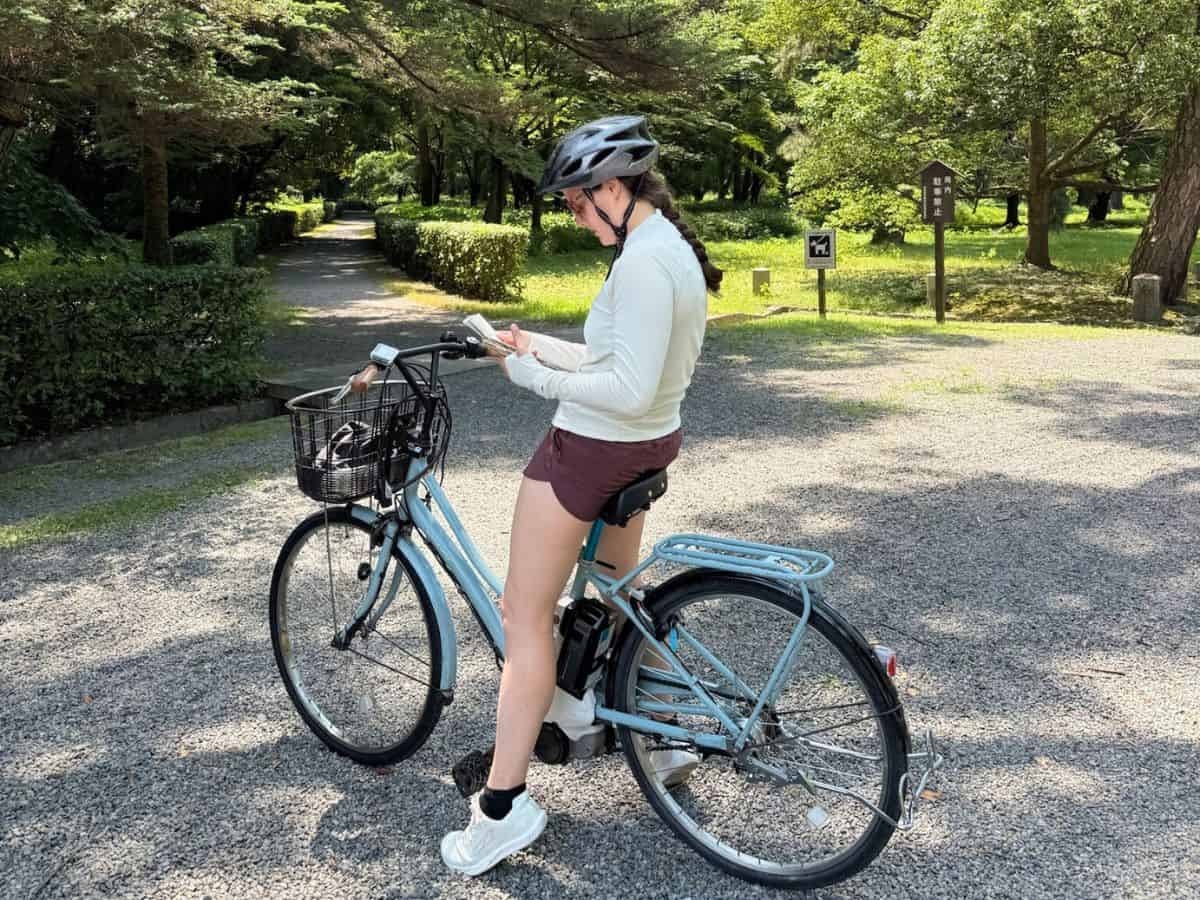 Liz referring to a map of the city while renting bikes in Kyoto