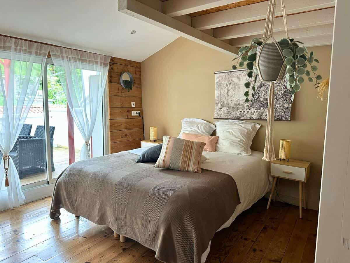 Cozy bed and terrace view of our studio at Plan B in Saint-Jean-Pied-de-Port
