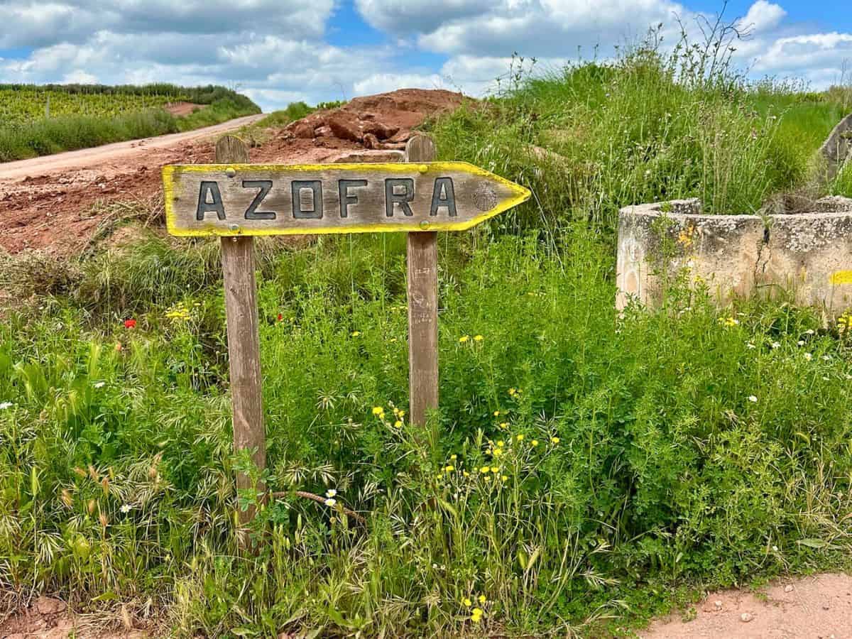 Camino Frances trail sign pointing the way to Azofra, an off-stage town along the route